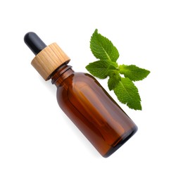 Photo of Bottle of essential oil and mint isolated on white, top view