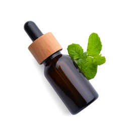 Photo of Bottle of essential oil and mint isolated on white, top view