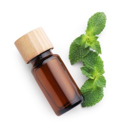 Photo of Bottle of essential oil and mint isolated on white, top view