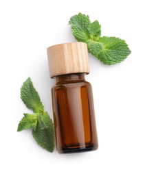 Bottle of essential oil and mint isolated on white, top view