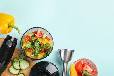 Photo of Hand blender kit, fresh vegetables and parsley on light blue background, flat lay. Space for text