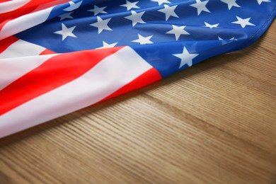 Photo of Flag of USA on wooden table, closeup. Space for text