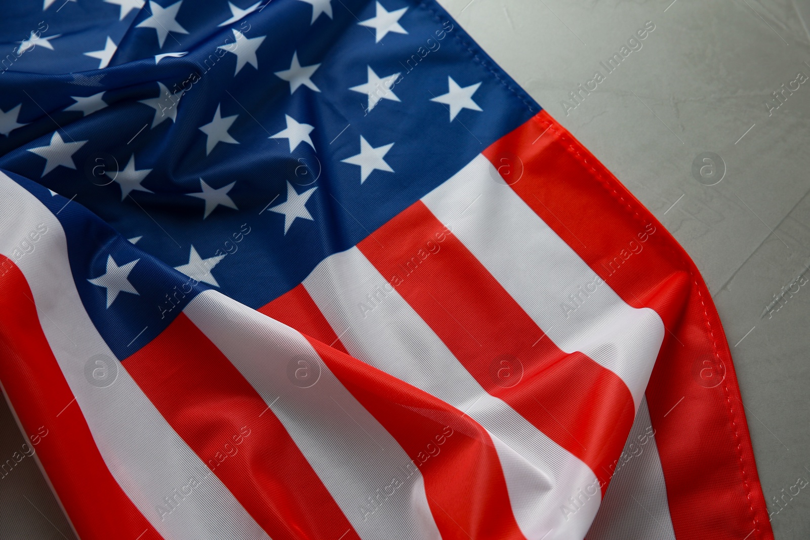 Photo of Flag of USA on light grey table, top view