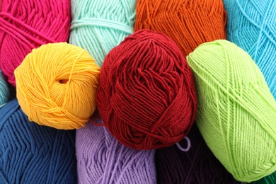 Photo of Many beautiful bright yarns as background, above view