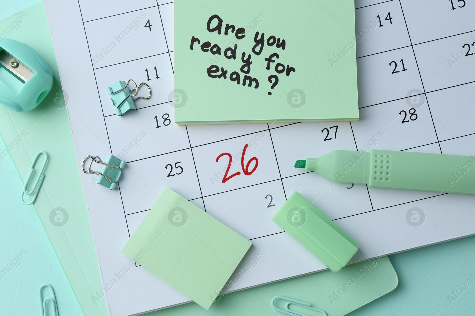 Photo of Paper note with question Are You Ready For Exam and stationery on light green background, flat lay