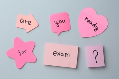 Photo of Sticky notes with question Are You Ready For Exam and stationery on grey background, flat lay