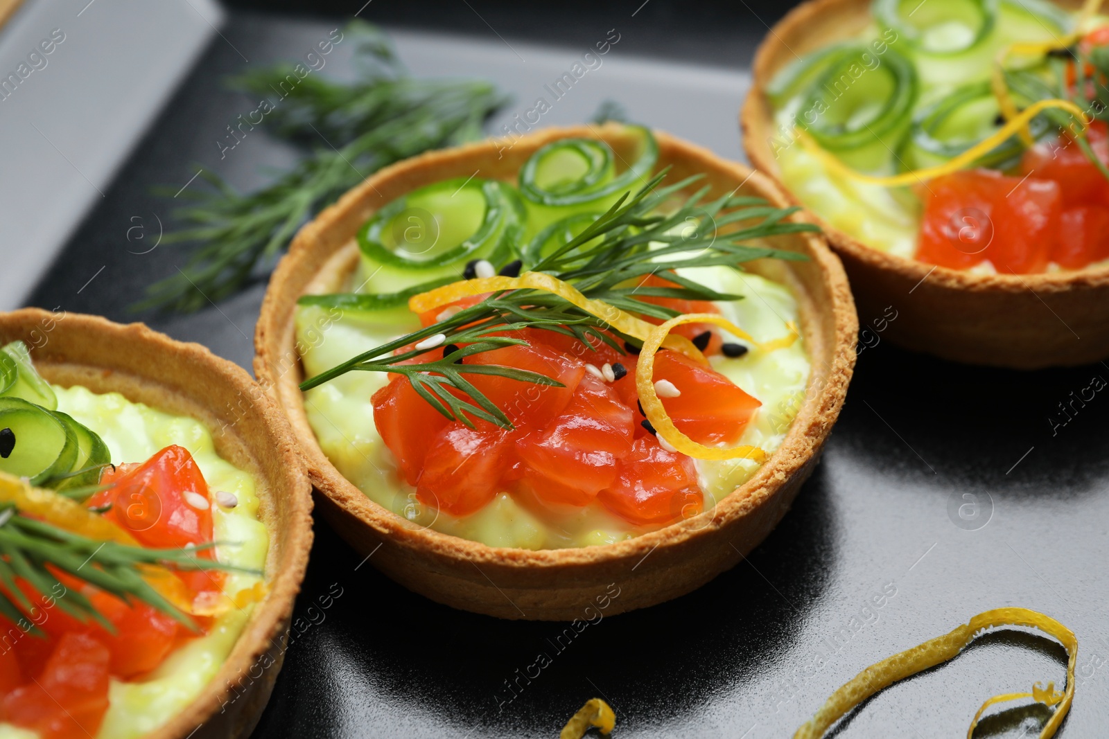 Photo of Delicious canapes with salmon on plate, closeup