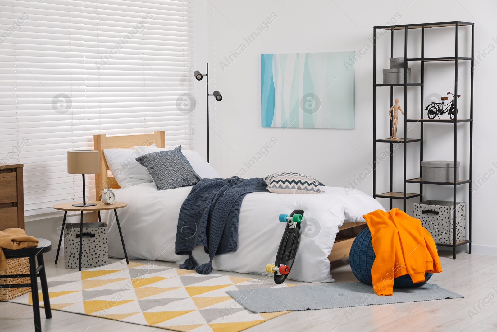 Photo of Teen's room interior with modern furniture and beautiful picture on wall