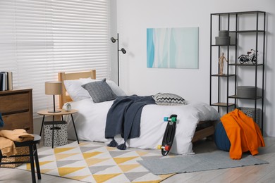 Teen's room interior with modern furniture and beautiful picture on wall