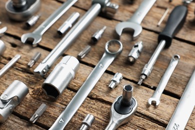 Different auto mechanic's tools on wooden table