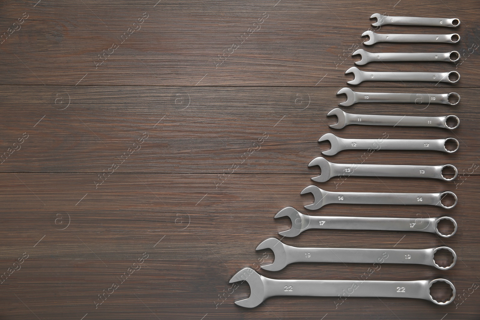 Photo of Auto mechanic's tools on wooden table, flat lay. Space for text