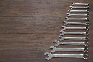 Auto mechanic's tools on wooden table, flat lay. Space for text