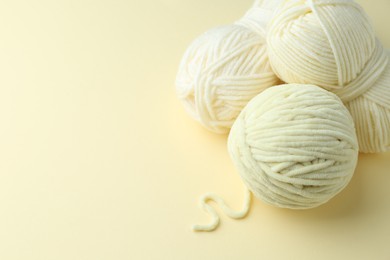 Skeins of plush yarn on beige background, space for text. Knitting material