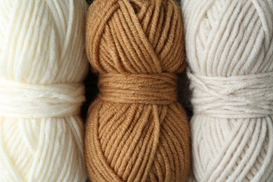 Photo of Three skeins of yarn as background, top view. Knitting material