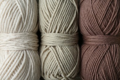 Photo of Three skeins of yarn as background, top view. Knitting material