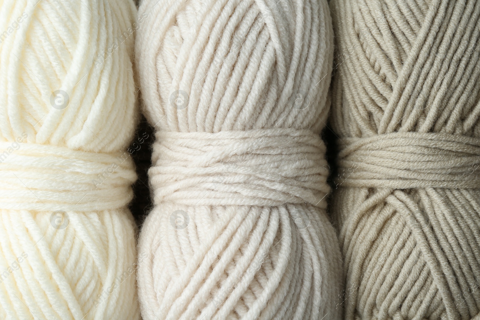 Photo of Three skeins of yarn as background, top view. Knitting material