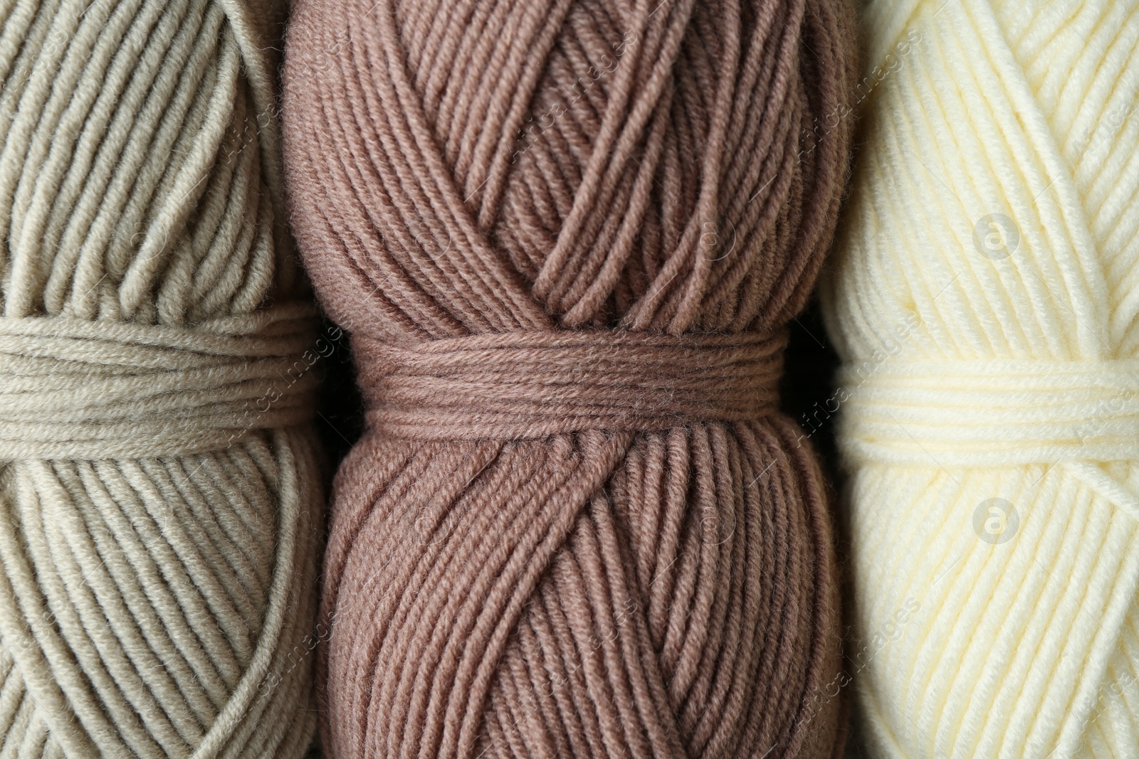 Photo of Three skeins of yarn as background, top view. Knitting material