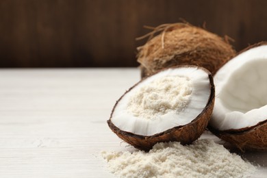 Photo of Fresh coconut flour and nuts on wooden table, space for text