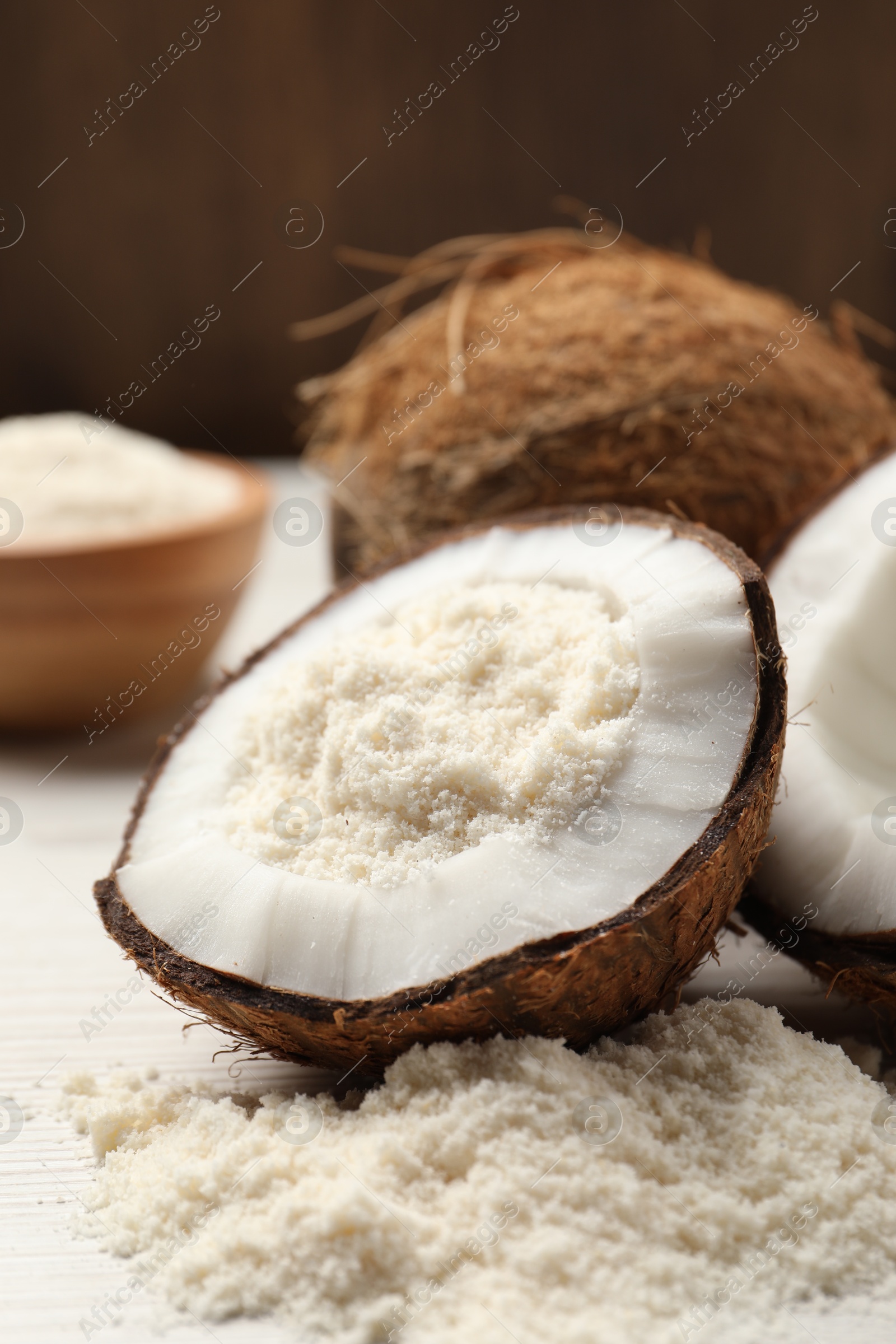 Photo of Fresh coconut flour and nuts on wooden table