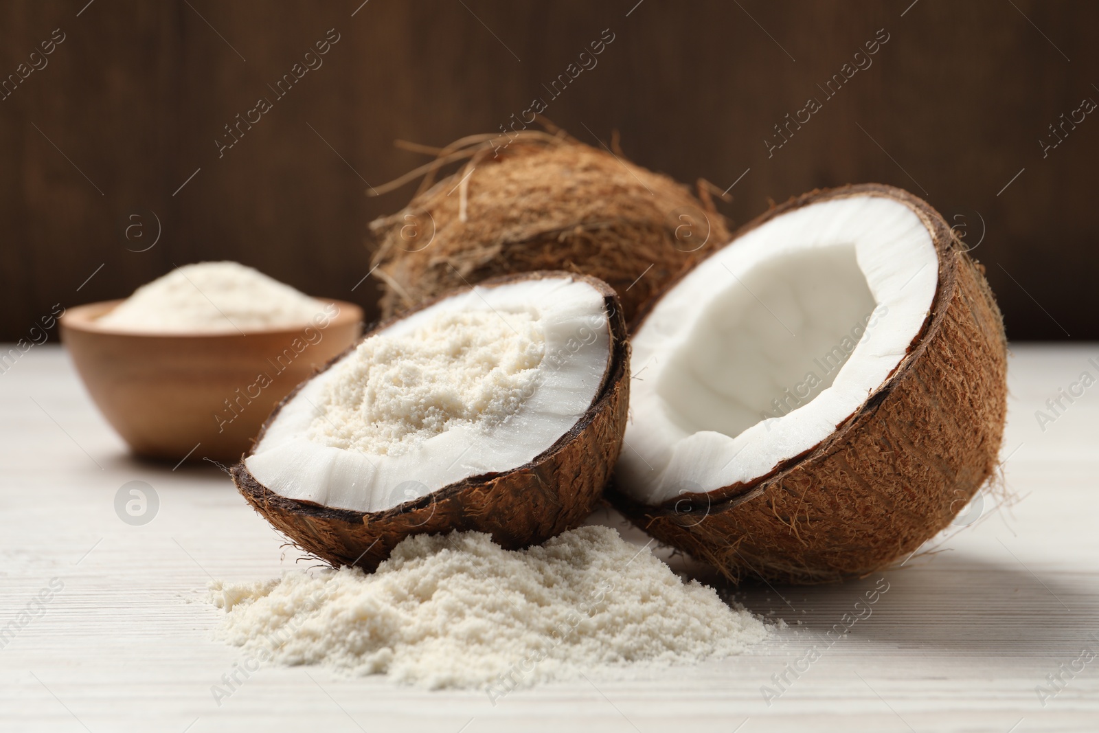 Photo of Fresh coconut flour and nuts on wooden table