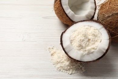 Photo of Fresh coconut flour and nuts on wooden table, space for text