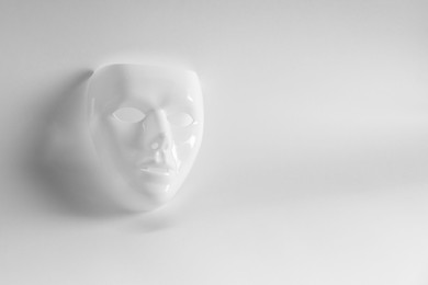 Plastic face mask on white background, space for text. Theatrical performance