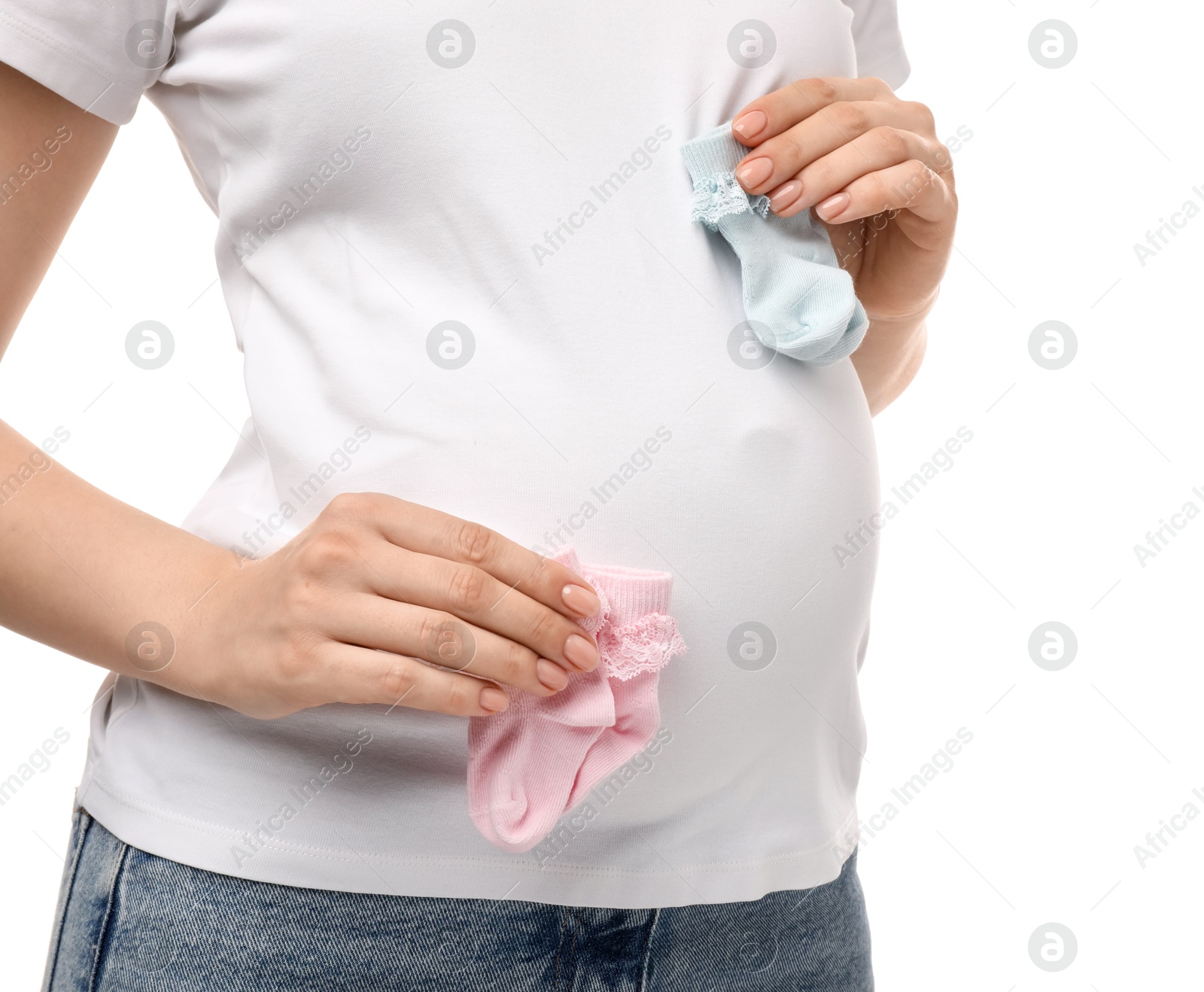 Photo of Expecting twins. Pregnant woman holding two pairs of socks on white background, closeup