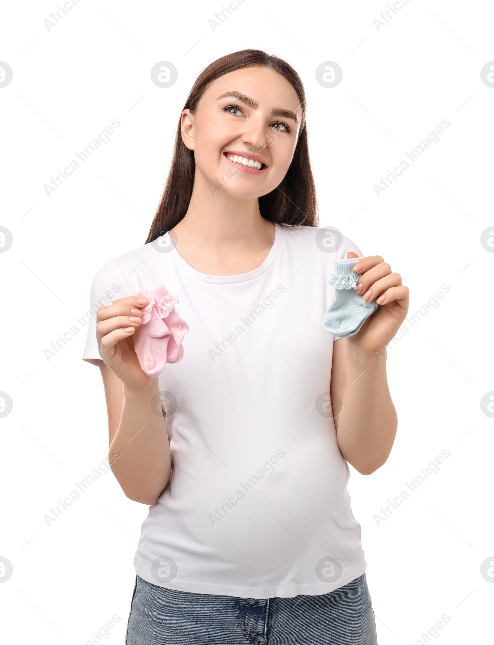 Photo of Expecting twins. Pregnant woman holding two pairs of socks on white background