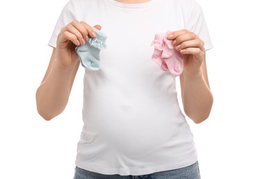 Photo of Expecting twins. Pregnant woman holding two pairs of socks on white background, closeup