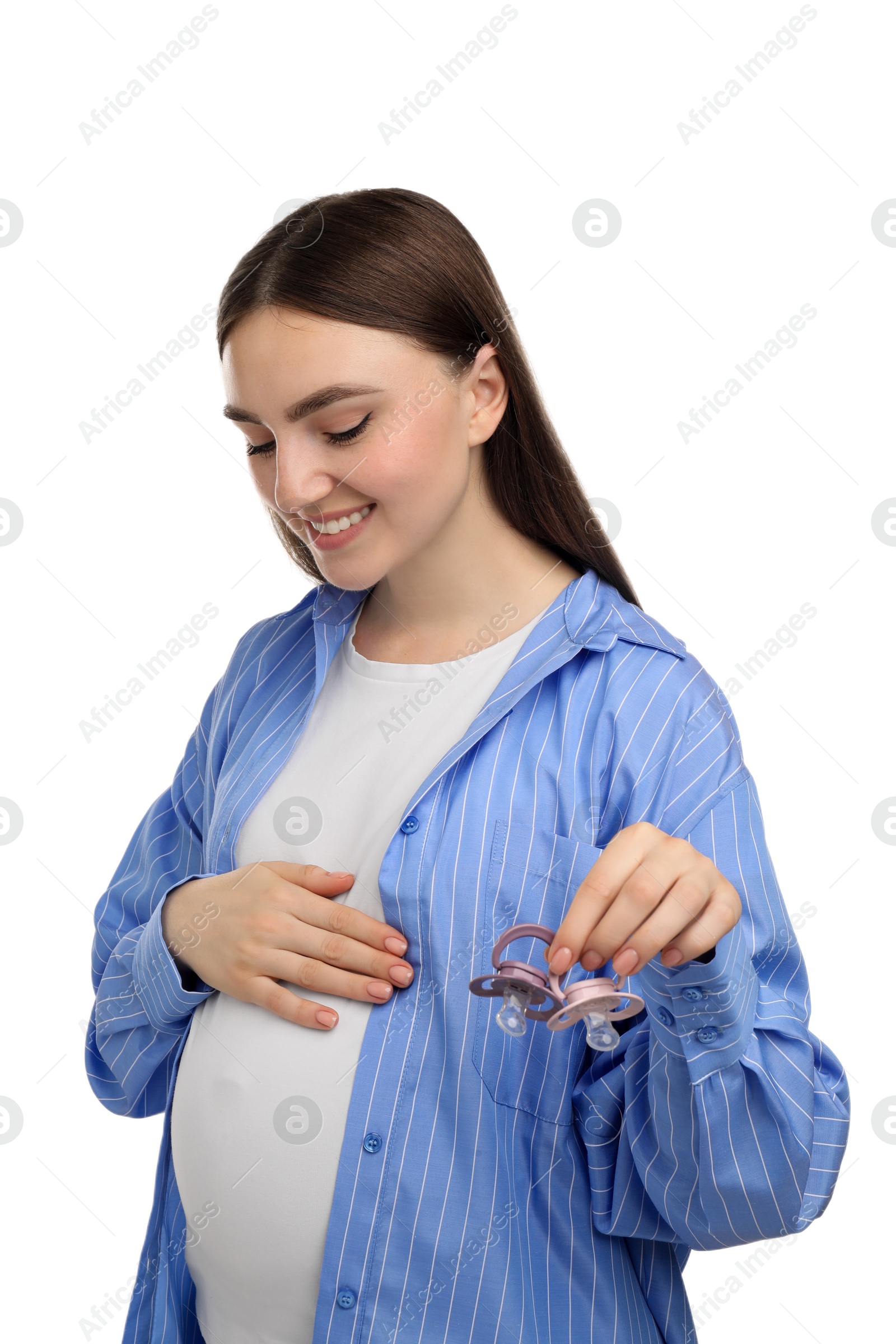 Photo of Expecting twins. Pregnant woman holding two pacifiers on white background