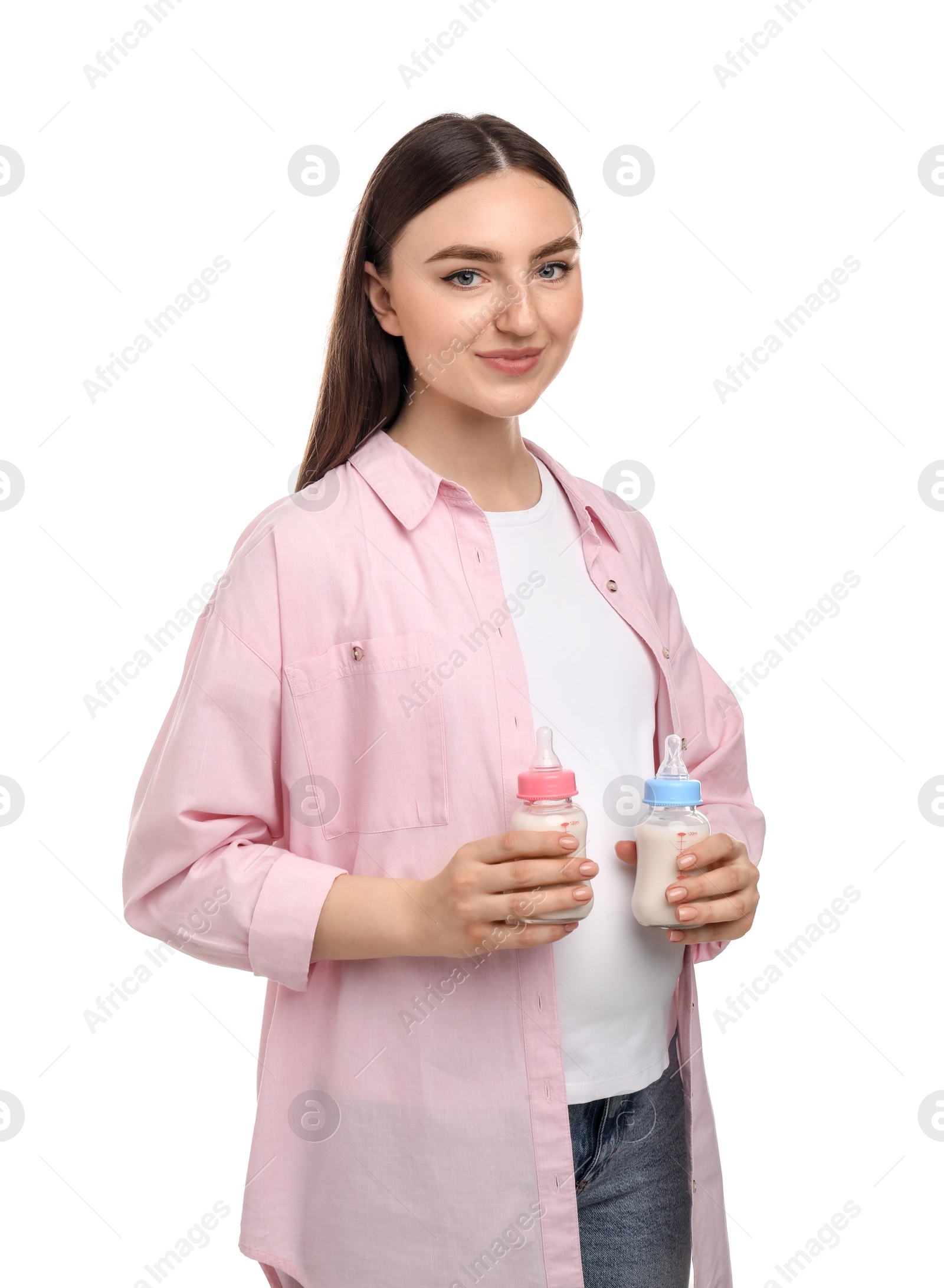 Photo of Expecting twins. Pregnant woman holding two bottles with milk on white background