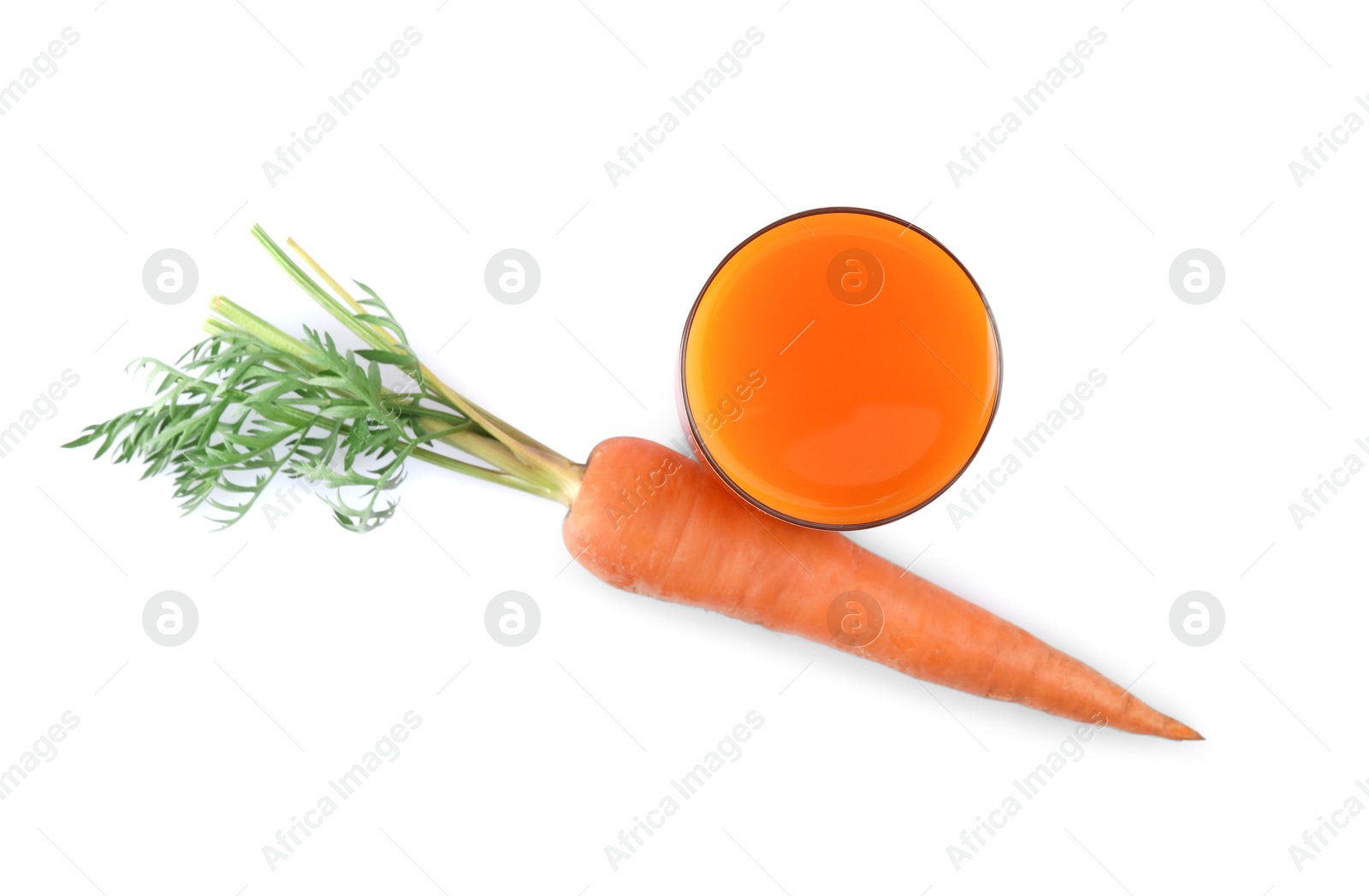 Photo of Healthy carrot juice in glass and fresh vegetable isolated on white, top view