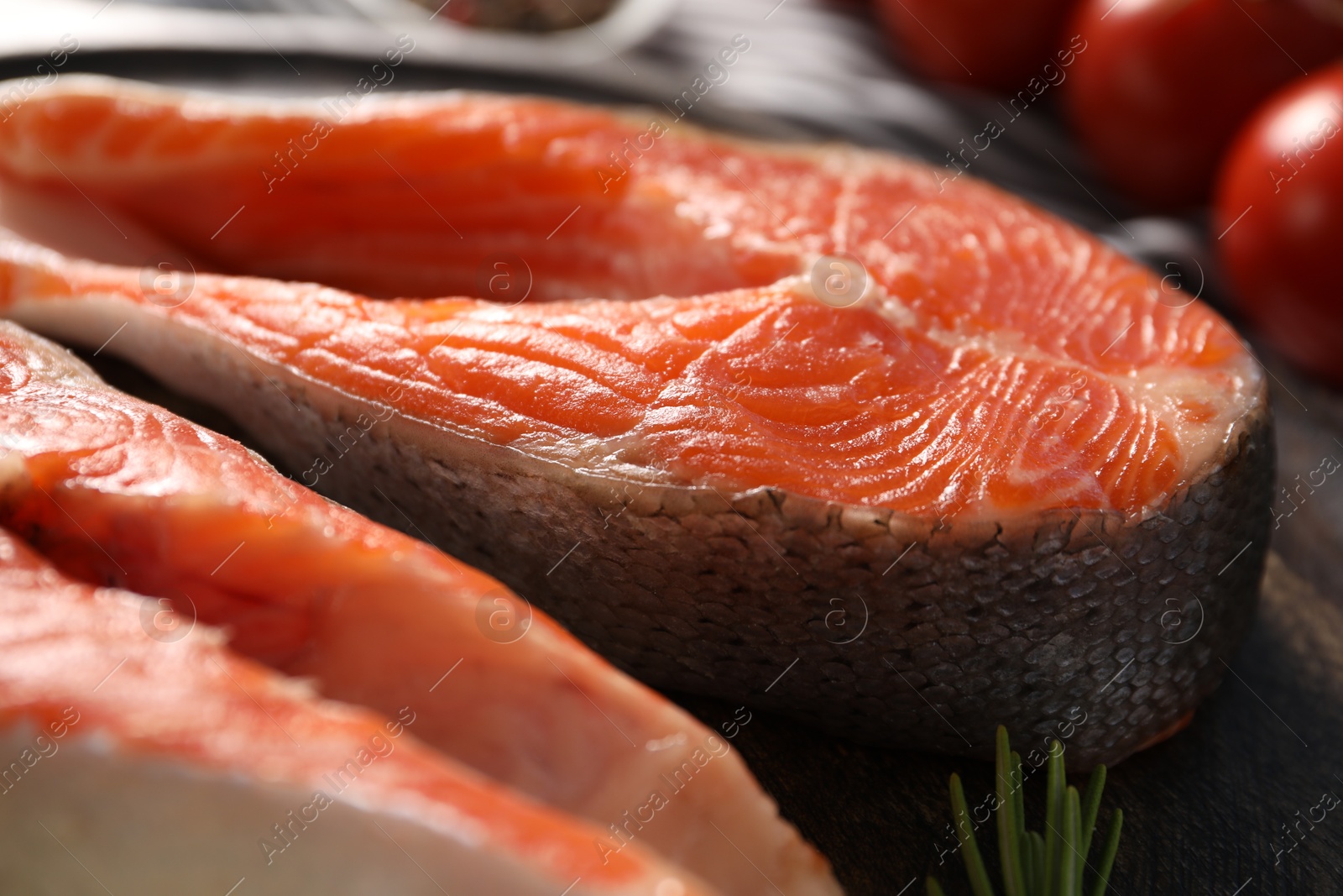 Photo of Fresh salmon steaks on table, closeup view