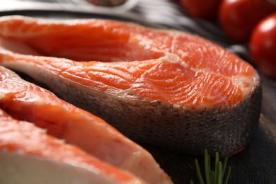 Photo of Fresh salmon steaks on table, closeup view