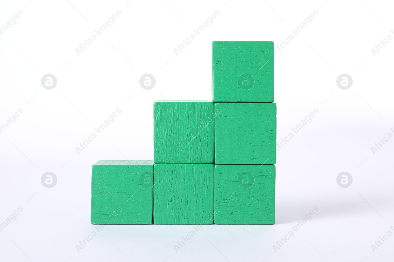 Photo of Many green wooden cubes on white background