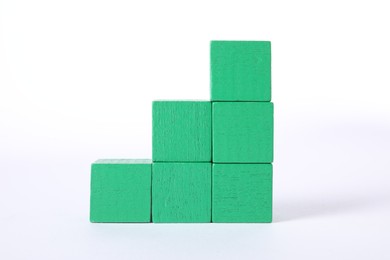 Photo of Many green wooden cubes on white background