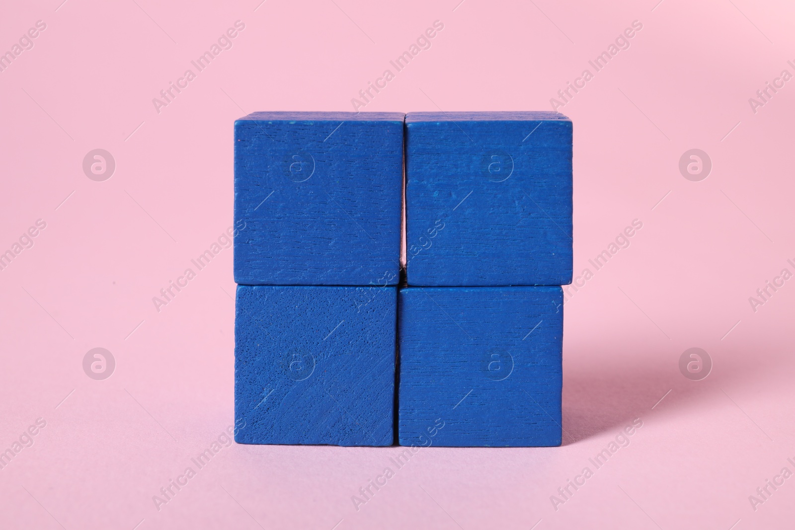 Photo of Many blank blue cubes on pink background, closeup