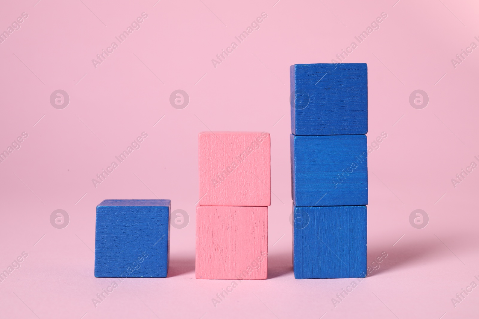 Photo of Many blank colorful cubes on pink background