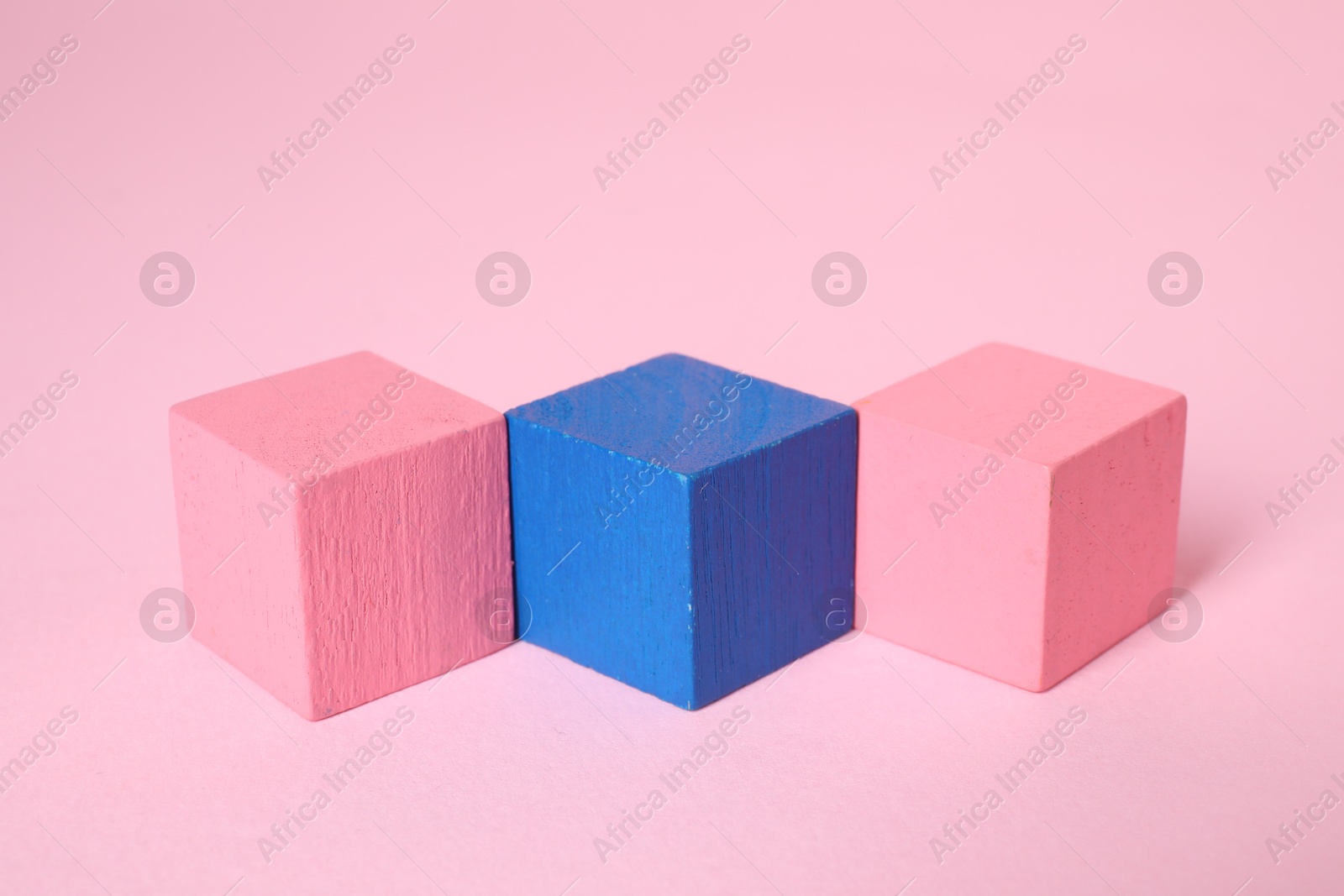 Photo of Many blank colorful cubes on pink background