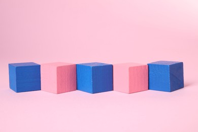 Photo of Many blank colorful cubes on pink background