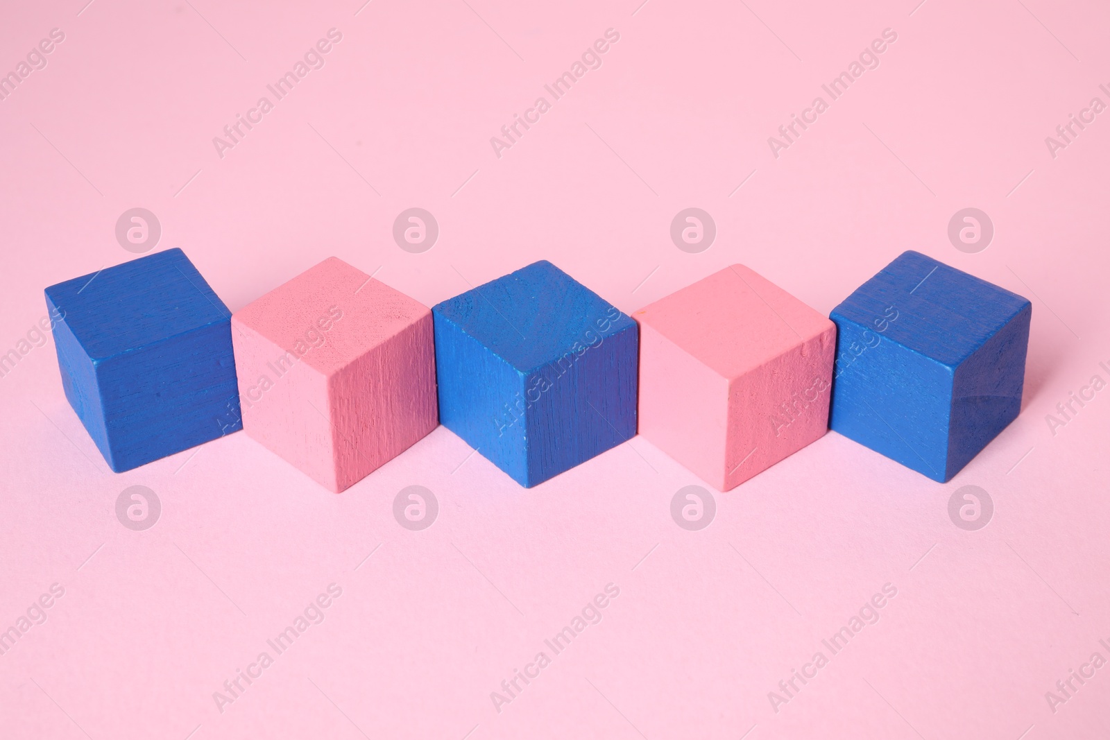 Photo of Many blank colorful cubes on pink background