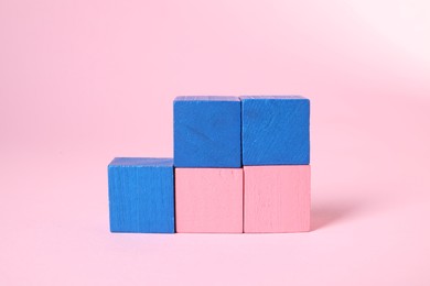 Photo of Many blank colorful cubes on pink background