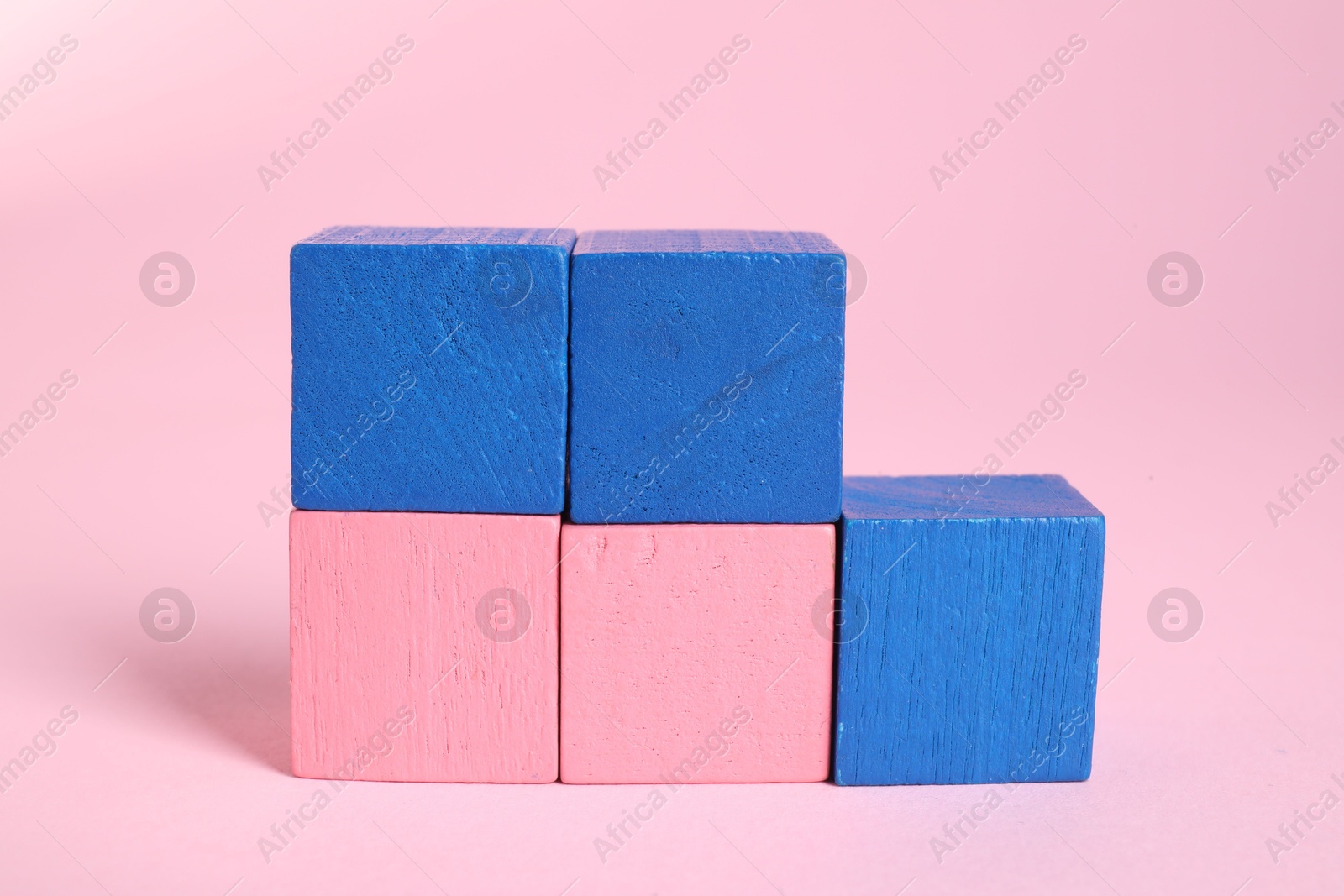 Photo of Many blank colorful cubes on pink background