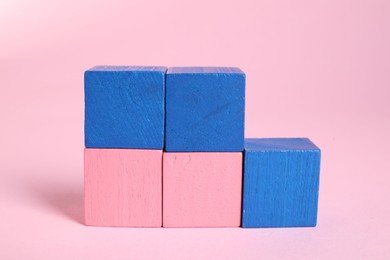 Photo of Many blank colorful cubes on pink background