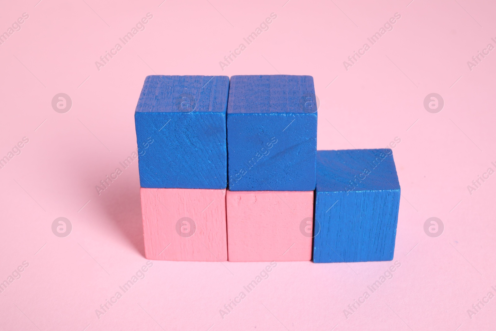 Photo of Many blank colorful cubes on pink background