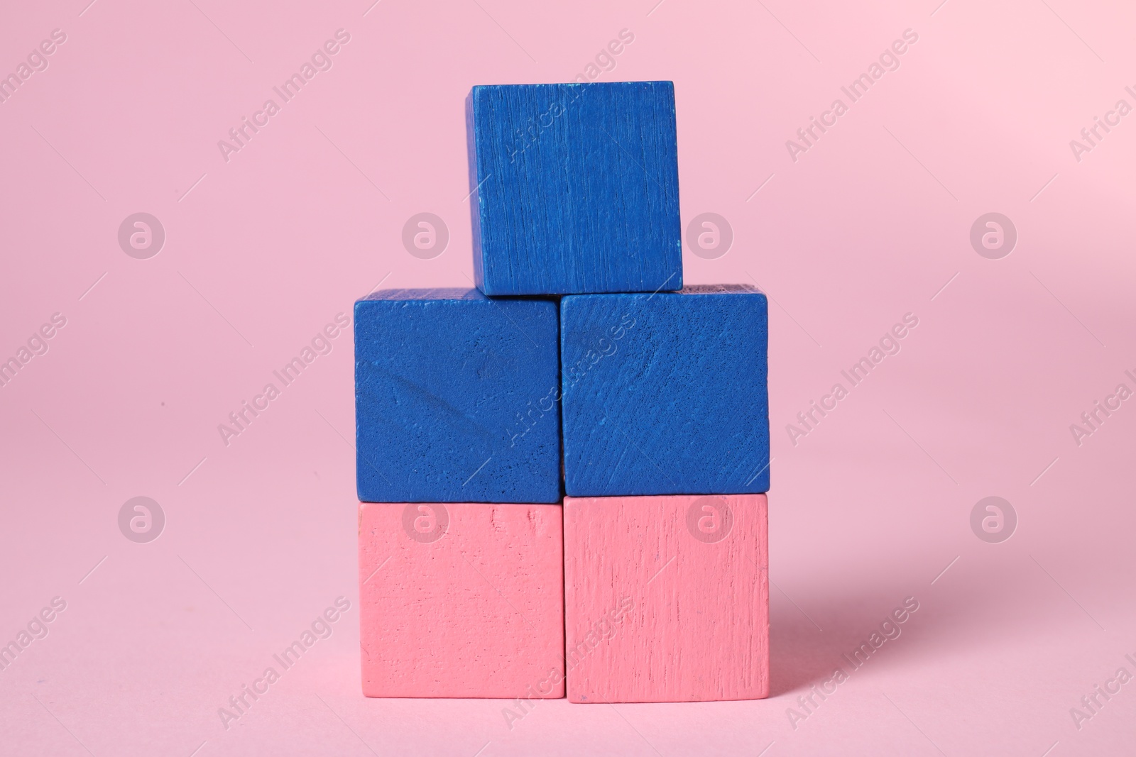 Photo of Many blank colorful cubes on pink background, closeup