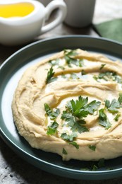 Photo of Delicious hummus with olive oil and parsley on table, closeup