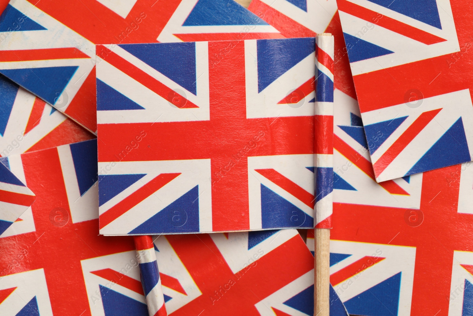 Photo of Small paper flags of United Kingdom as background, top view