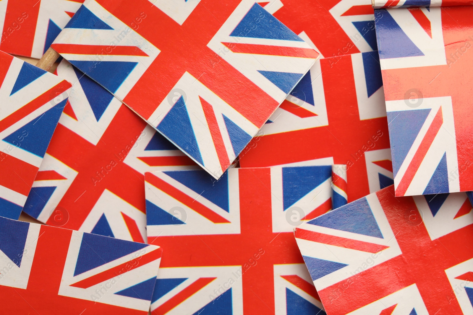 Photo of Small paper flags of United Kingdom as background, top view