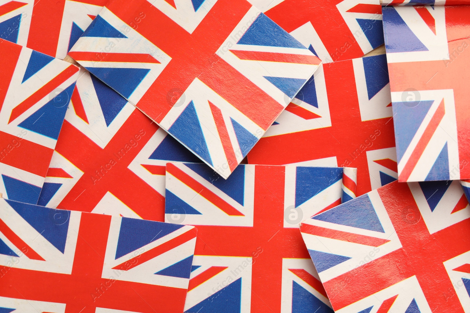 Photo of Small paper flags of United Kingdom as background, top view